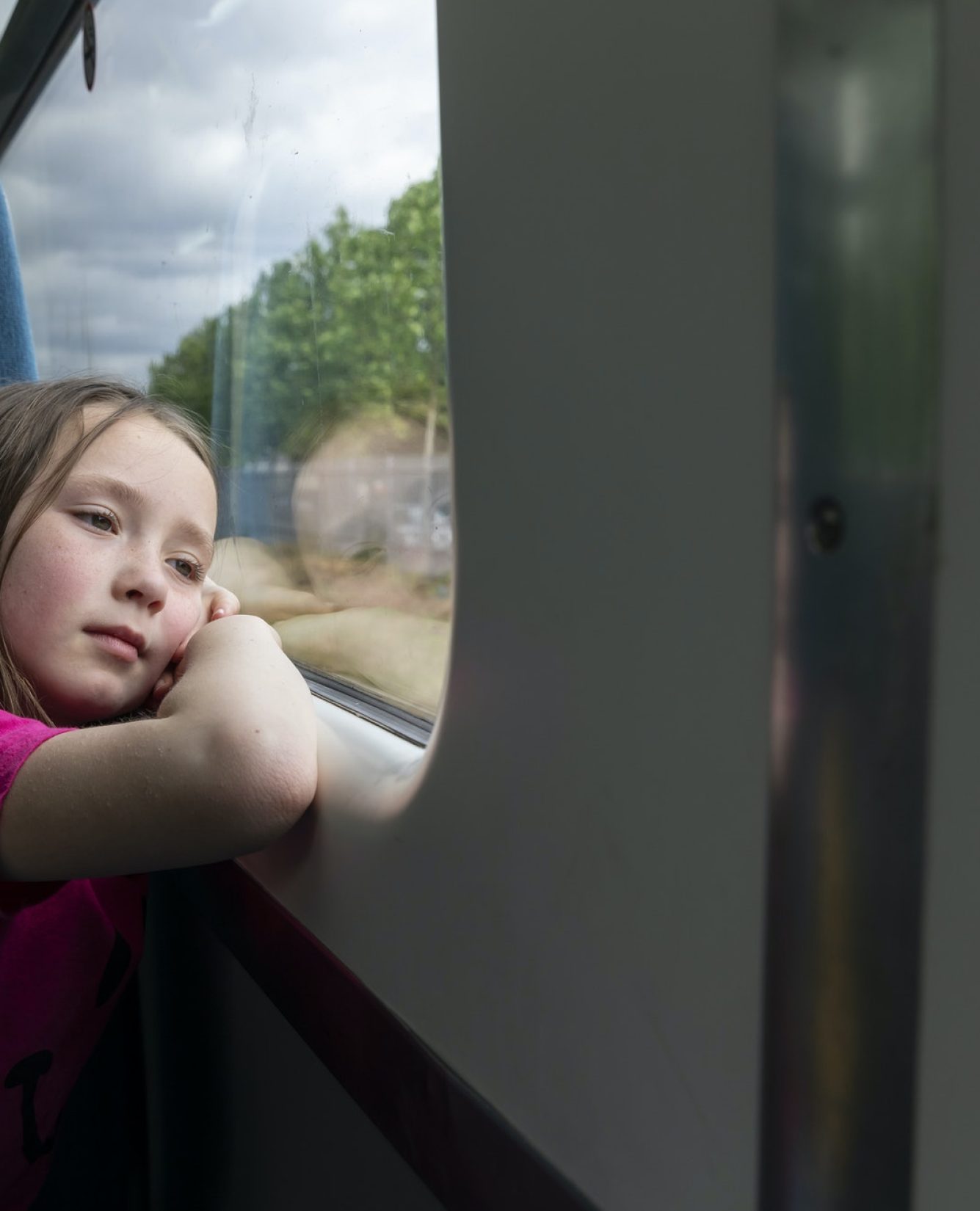 Girl looking through window in train